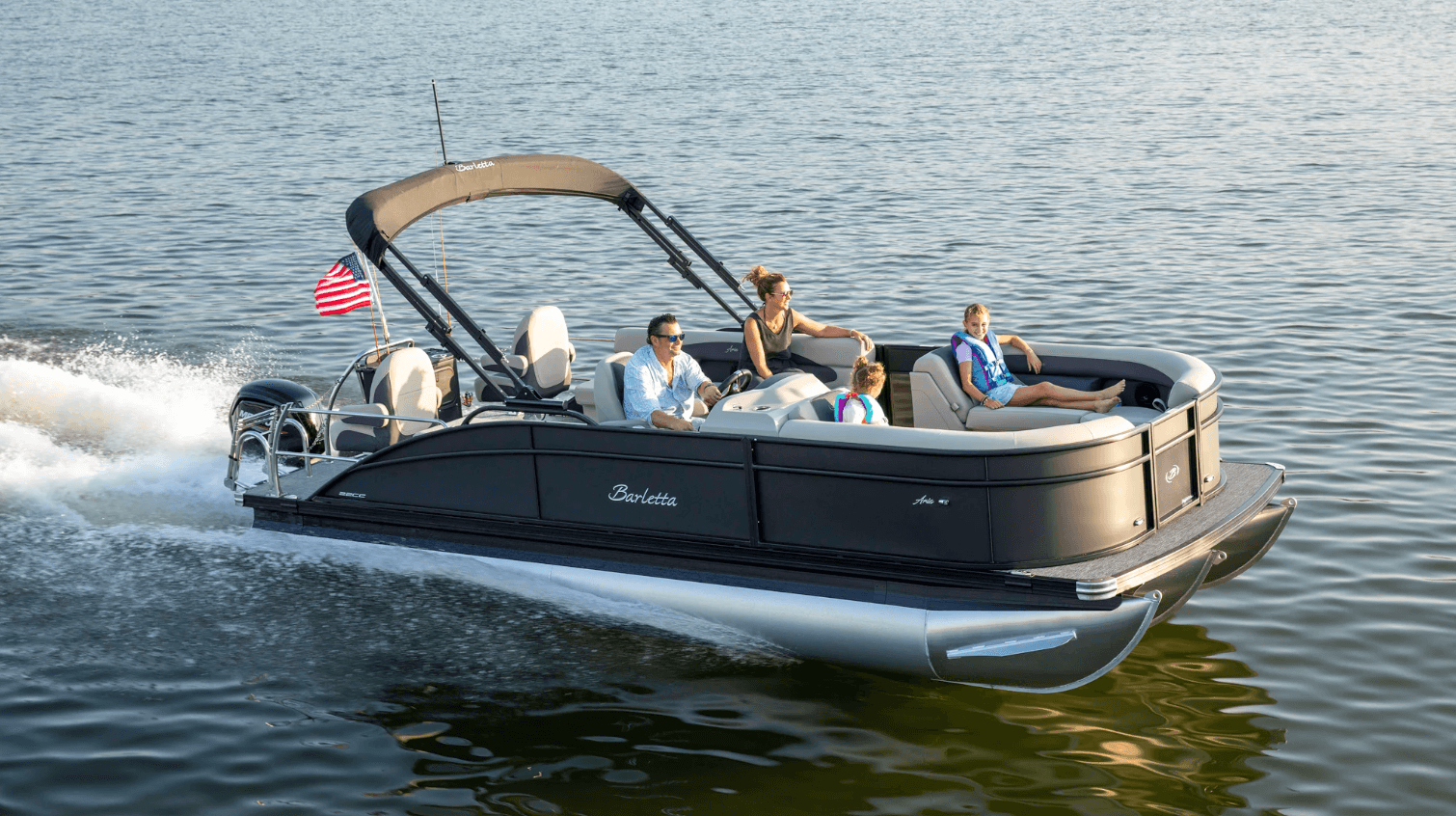 Pontoon boat cruising on calm lake waters with passengers enjoying ride