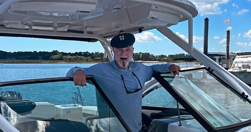 Charter captain posing on deck at marina before boat departure