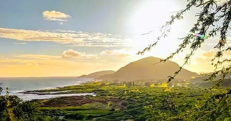 Sunrise coastal hike overlooking valley and ocean in Hawaii