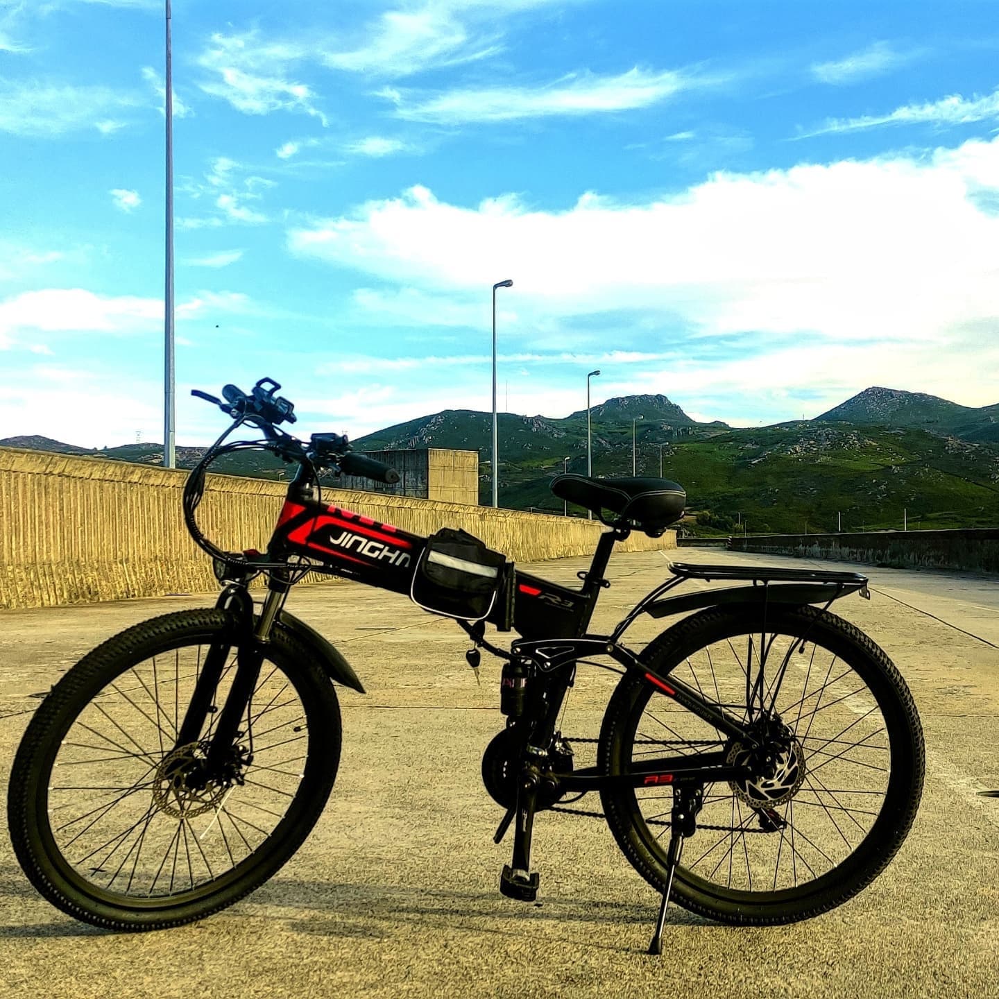 Electric mountain bike parked with mountain panorama sunset