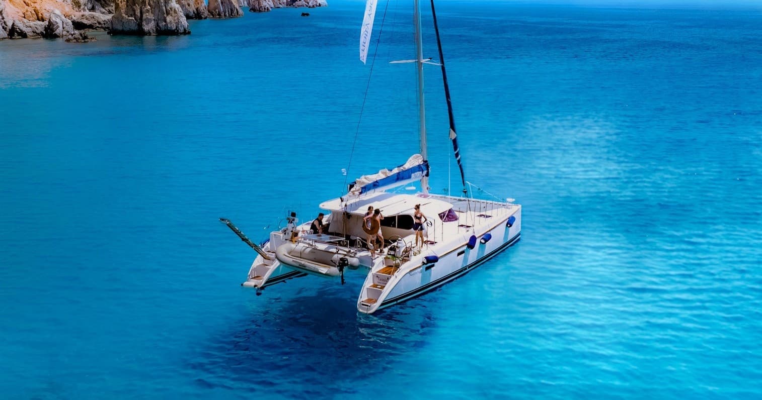 Catamaran sailing in turquoise Mediterranean sea, scenic cruise