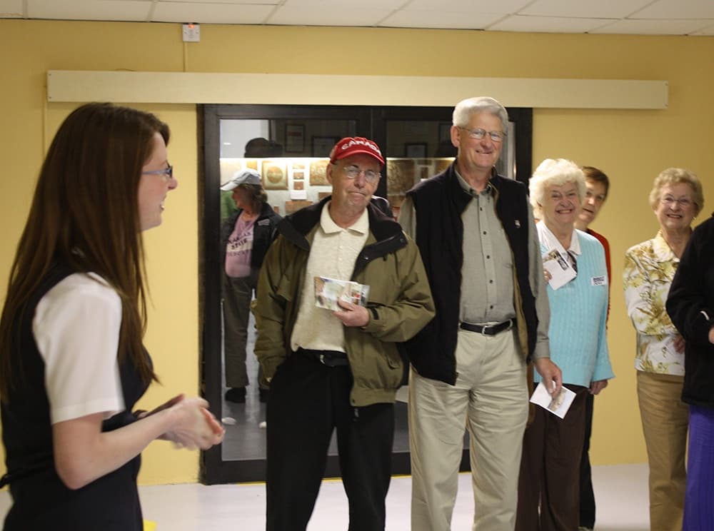 Visitors listening to guide inside Belleek Pottery tour room