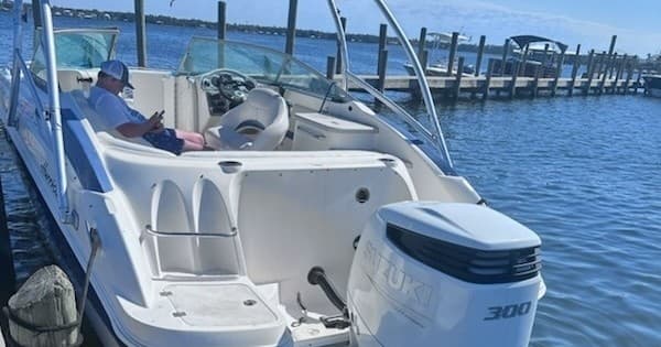 Powerboat cruising near Perdido Key docks on clear Gulf waters