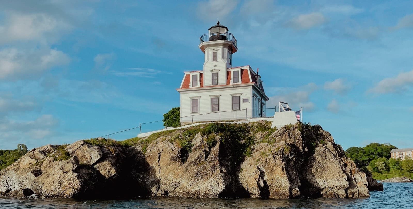 Pomham Rocks Lighthouse perched on rocky islet, coastal views