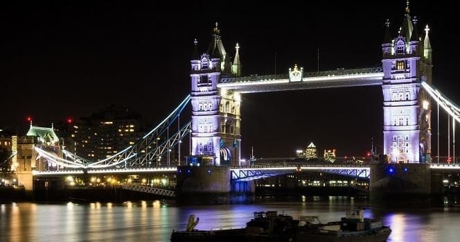 Tower Bridge illuminated at night over River Thames, London