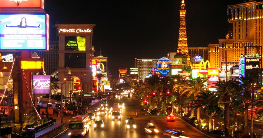 Nighttime Las Vegas boulevard view, busy traffic and neon signs