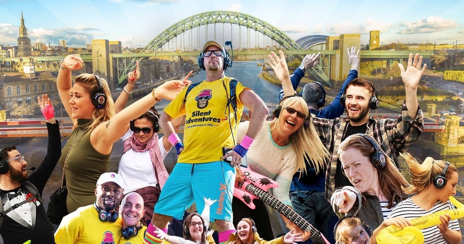 Silent disco walkers celebrating near iconic city bridge skyline