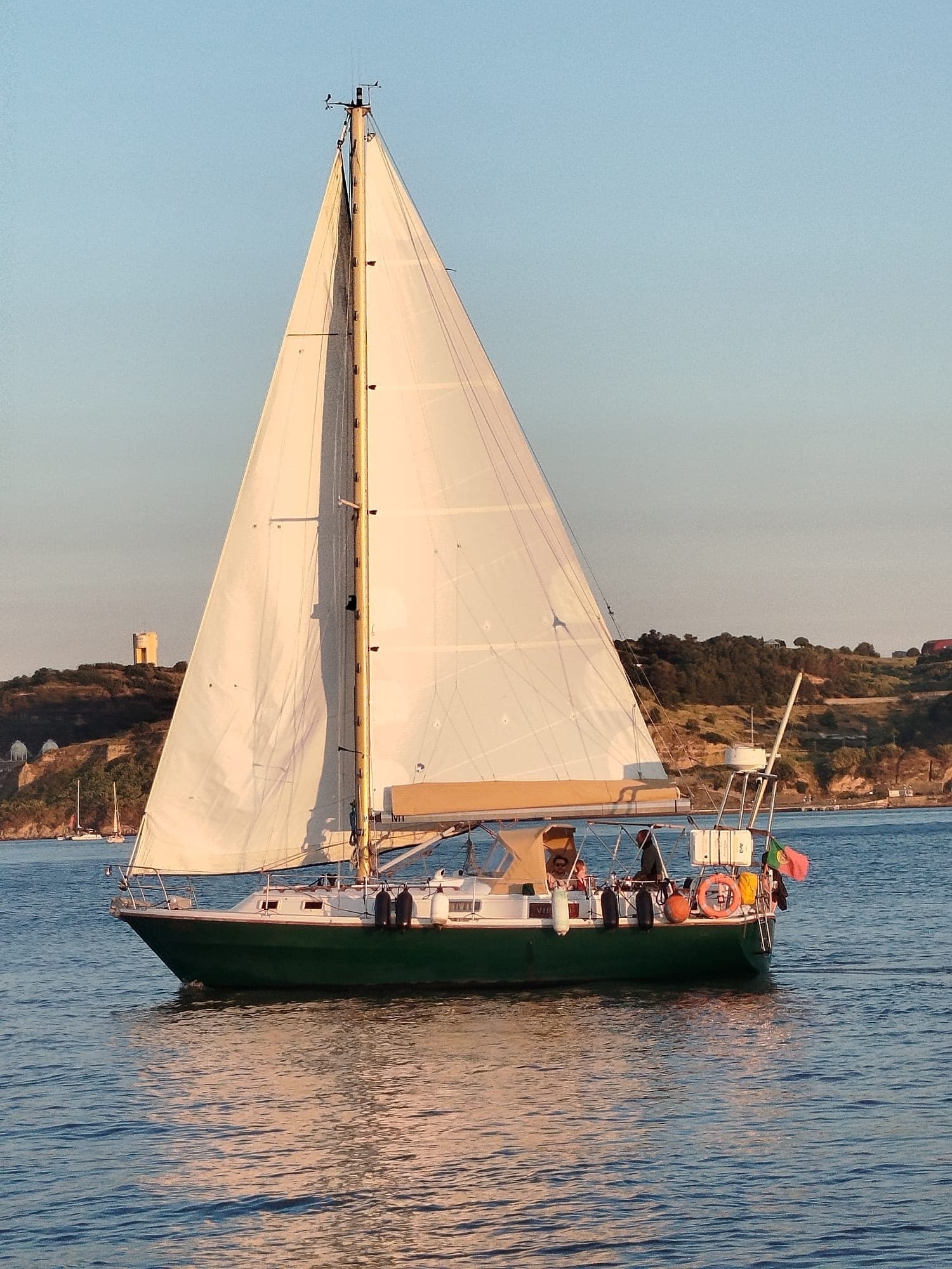 Classic sailboat under clear sky on Lisbon's Tagus River