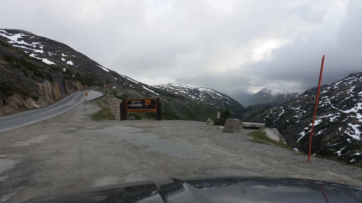 Mountain pass road with scenic overlooks and glacier-fed peaks