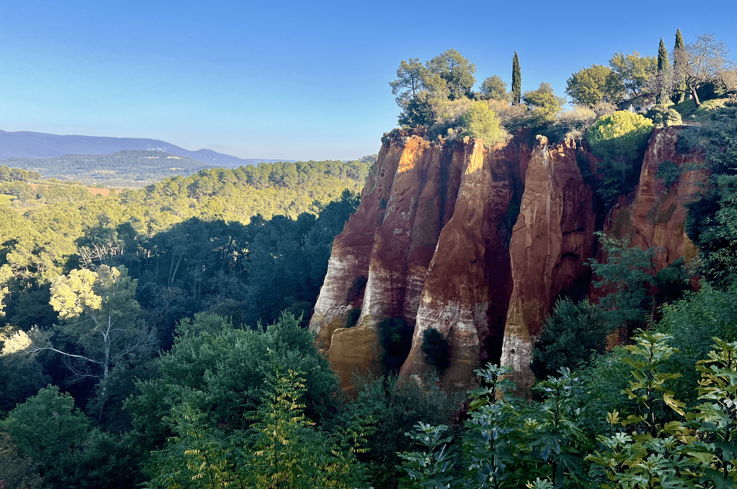 Hiking viewpoint over ochre cliffs and pine forests, Provence