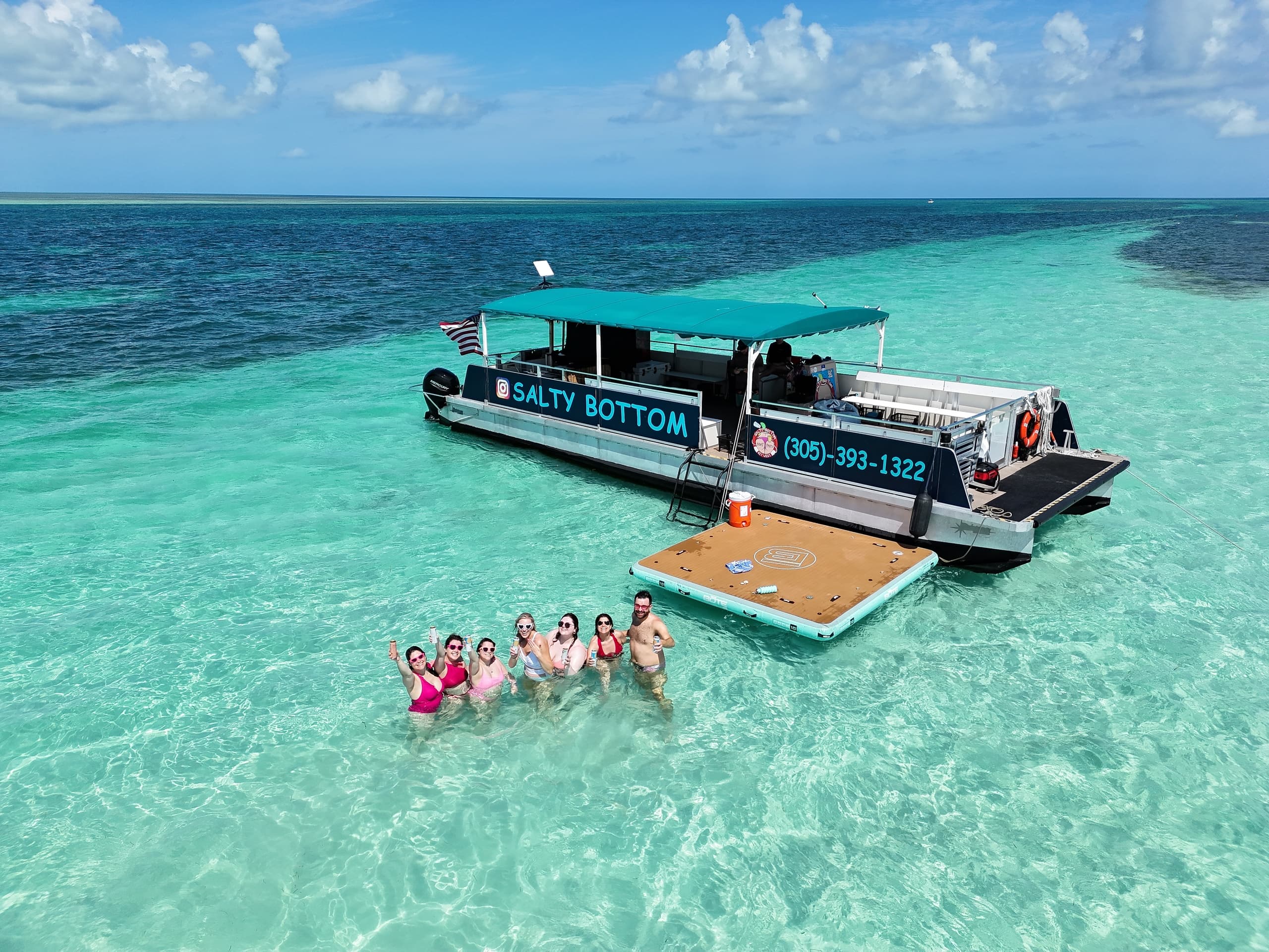 Group snorkeling and boat tour on clear turquoise Bahamian waters