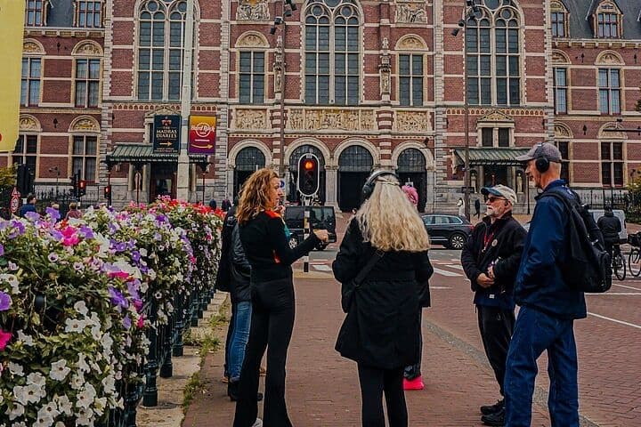 Small group walking tour in front of historic Amsterdam museum