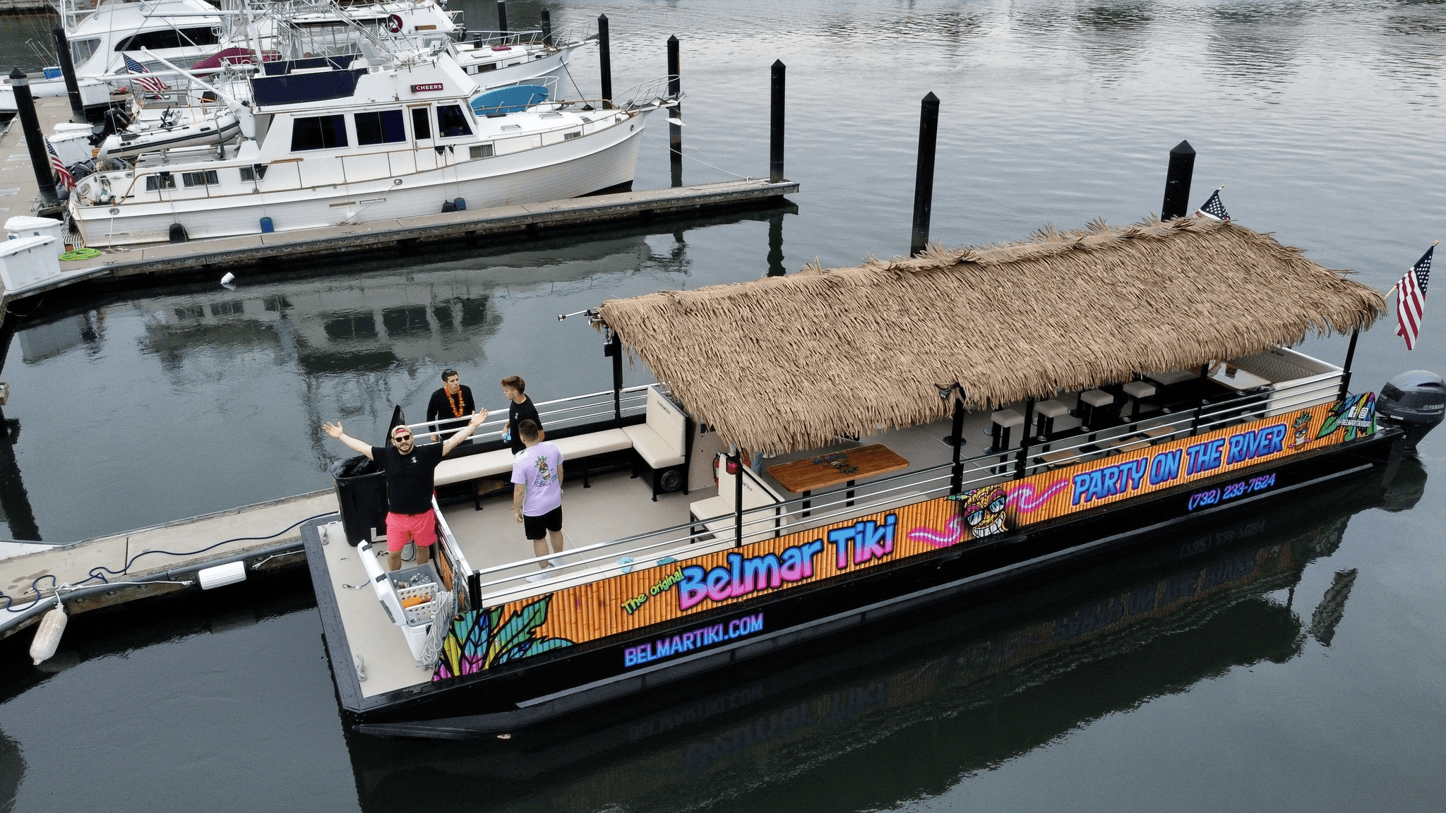 Aerial view of tiki boat docked at marina on river