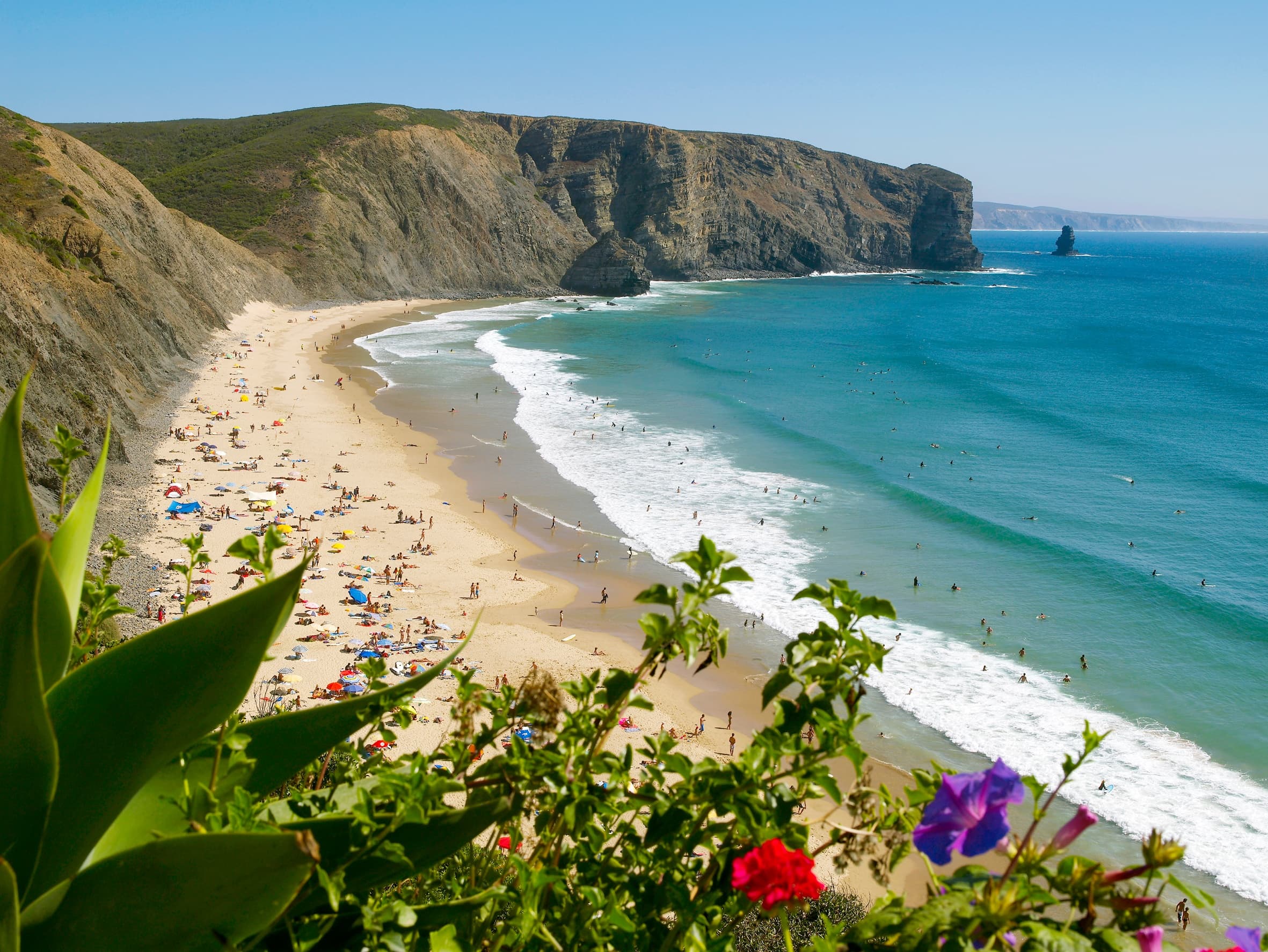 Sunny Algarve coastline view with sandy beach and cliffs