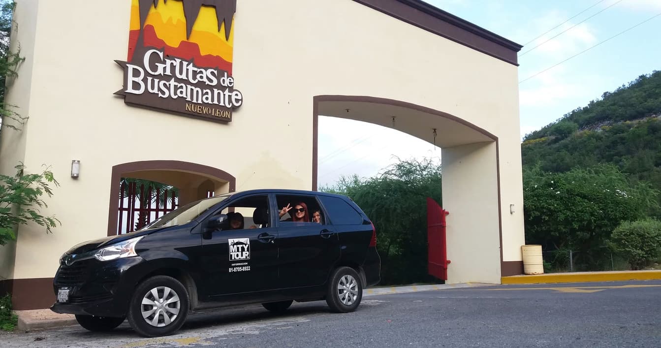 Tour vehicle parked at Grutas de Bustamante entrance, cave tour