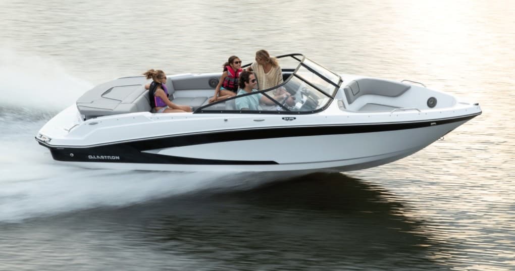 Speedboat bowrider cutting across calm water, lakeside cruise