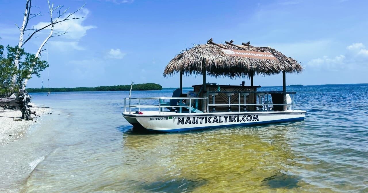 Thatched tiki boat anchored in Charlotte Harbor clear waters