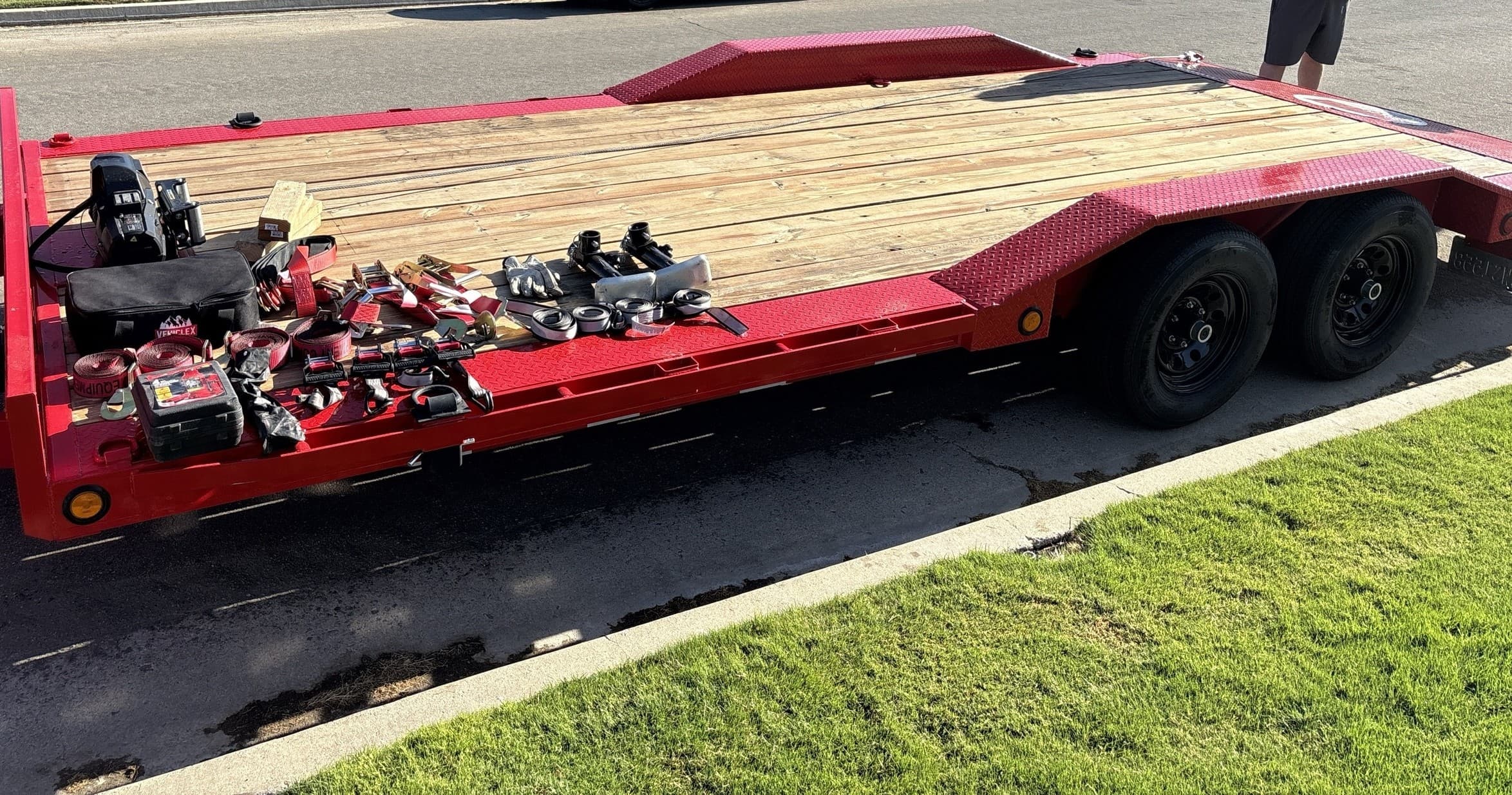 Low-profile car hauler trailer parked on roadside for transport