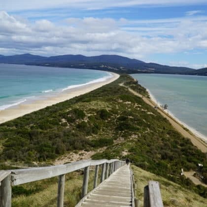 Boardwalk across sand spit to dramatic coastal vistas in Tasmania