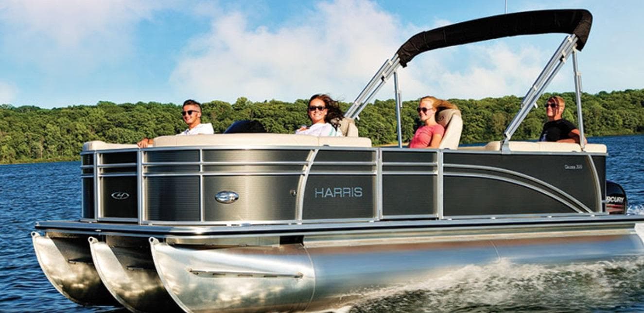 Pontoon boat cruising Lake Lanier with passengers enjoying sunset