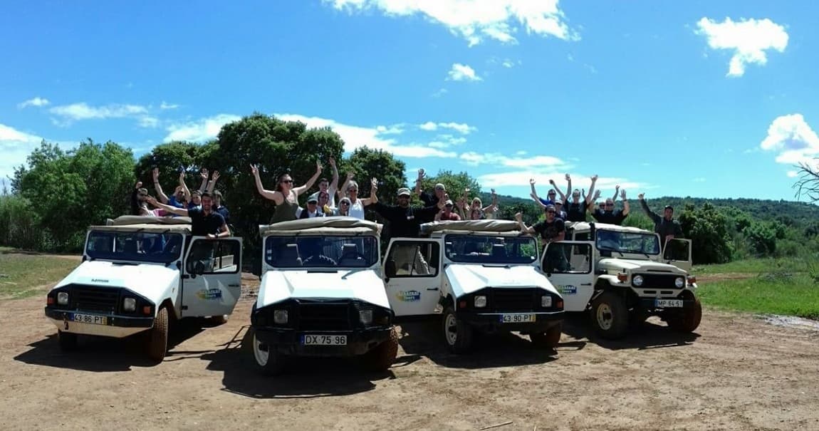 Off-road jeep convoy with excited riders on dirt trails, safari