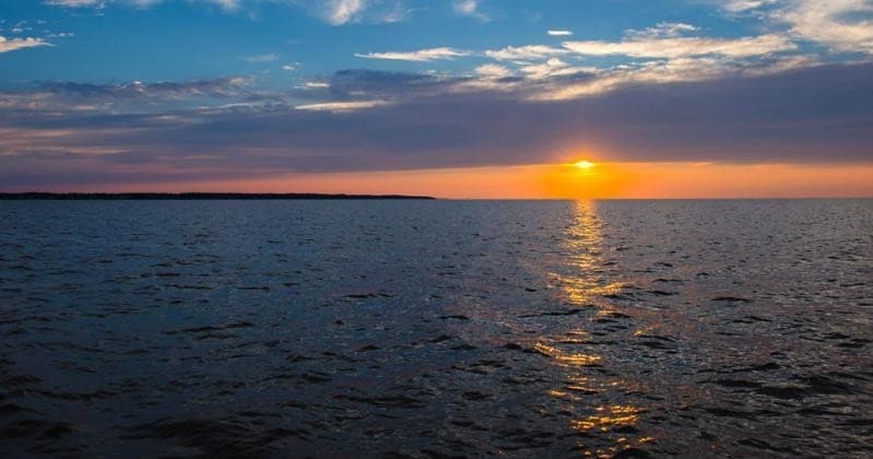 Sunset over Gulf waters from boat with golden reflection