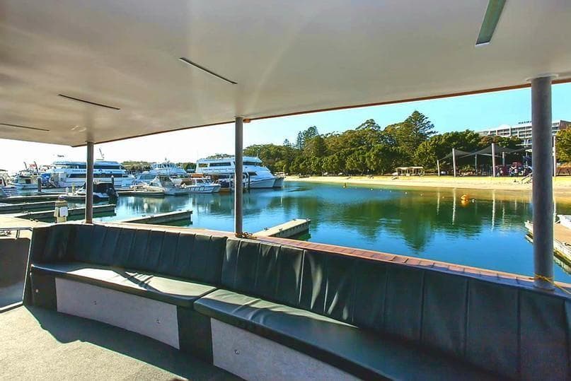 Covered boat lounge overlooking marina and calm harbor waters