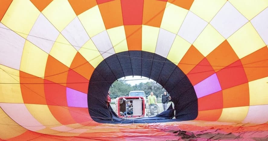 Inside hot air balloon envelope during inflation with crew