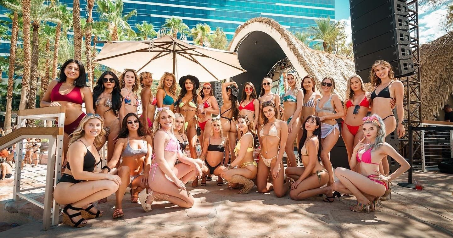 Pool party group lounging poolside at resort dayclub in Las Vegas