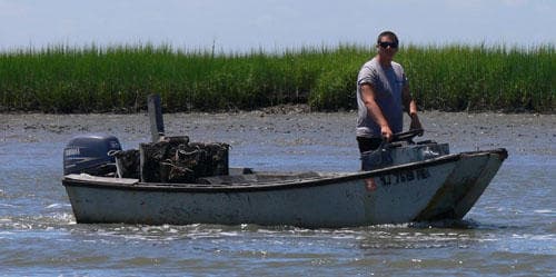 Small skiff navigating tidal marshes, saltwater fishing or work