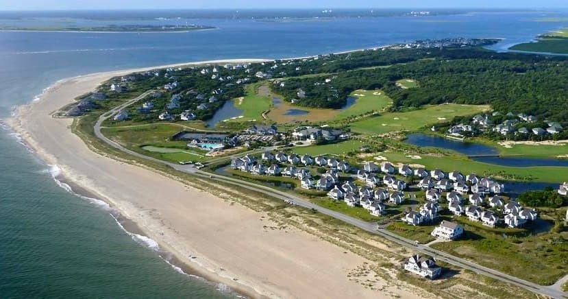 Wide aerial of beachfront community and dunes, ideal scenic tour
