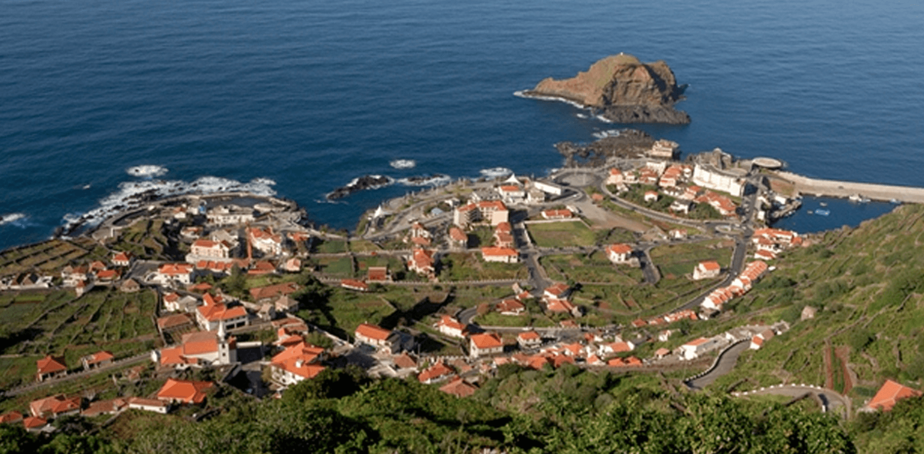 Aerial view of island village and harbor, coastal sightseeing