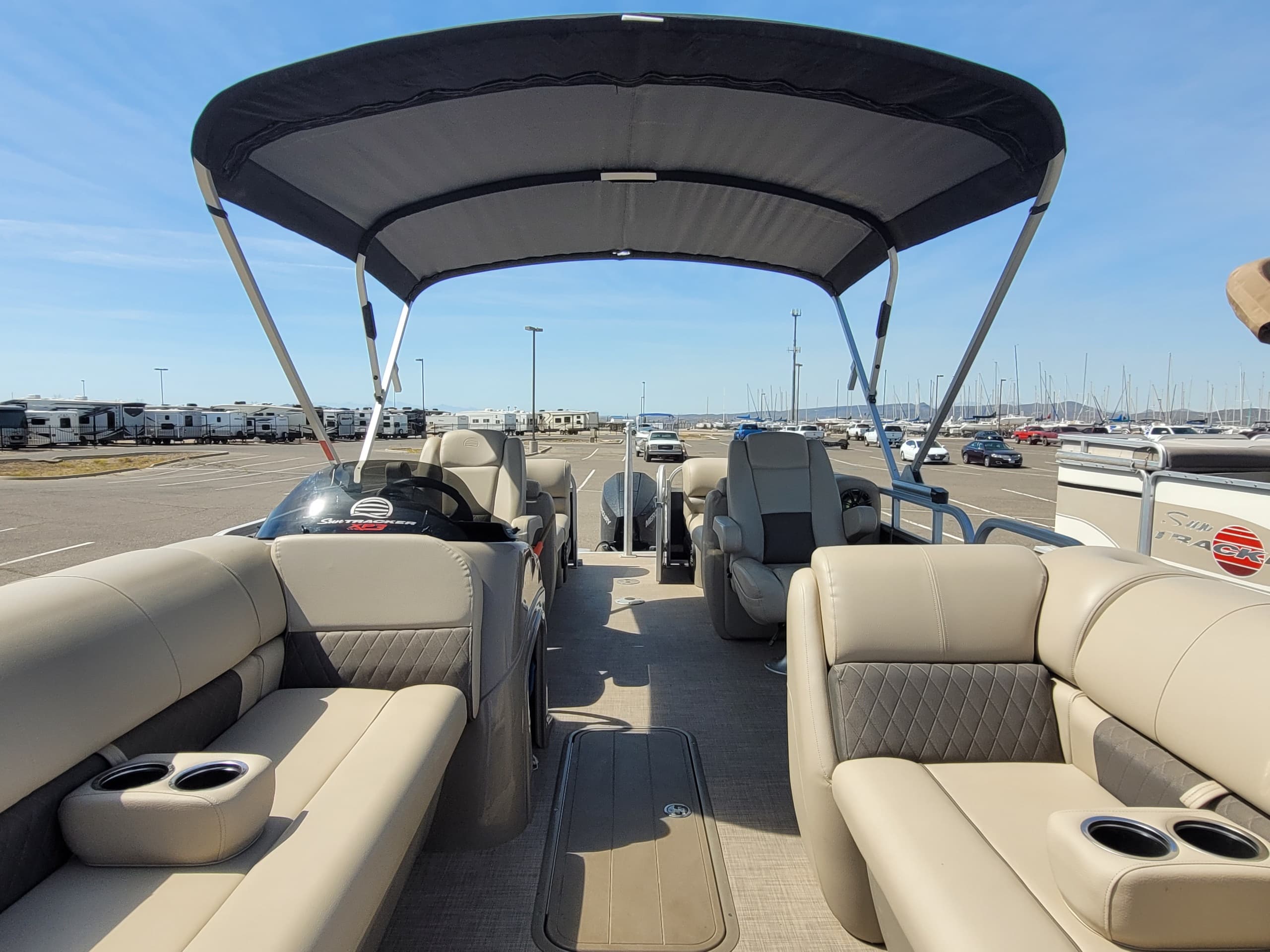 Pontoon boat with canopy docked at sunny marina, Arizona lake