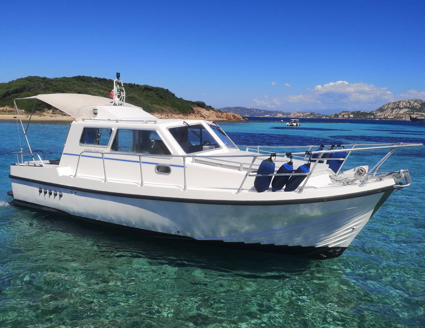 White motorboat on crystal Mediterranean waters near La Maddalena