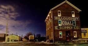 Old Willoughby Coal & Supply building lit at night