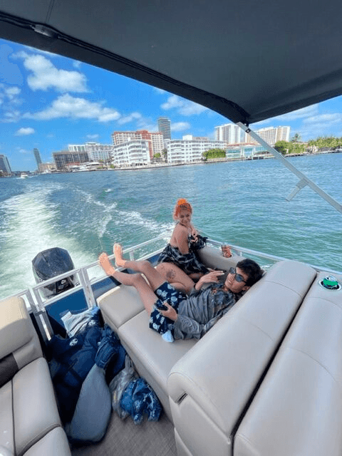 Passengers relaxing on pontoon cruising toward city skyline, bay tour