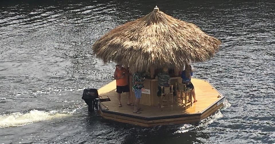 Tiki raft with passengers cruising calm Lake Havasu waters