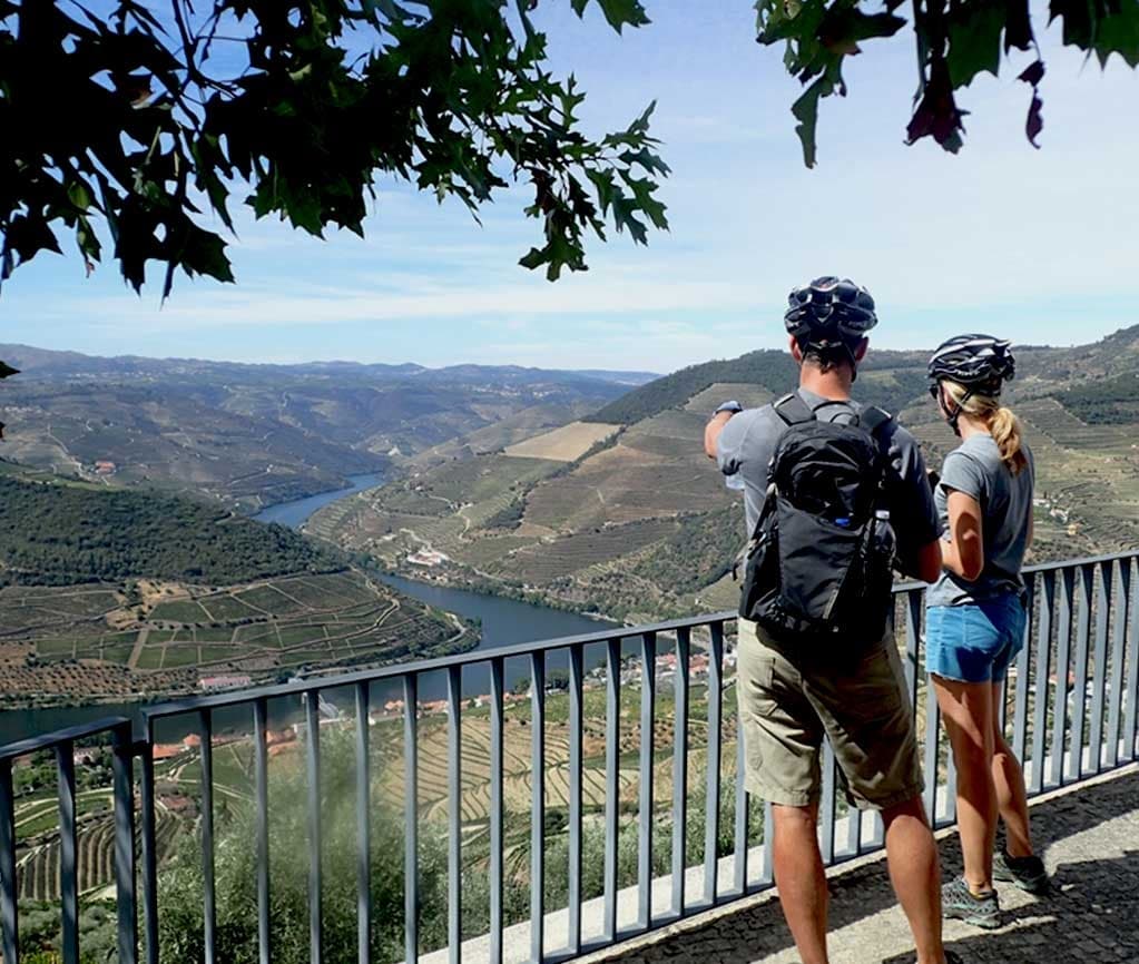 Couple viewing sweeping river gorge from scenic lookout
