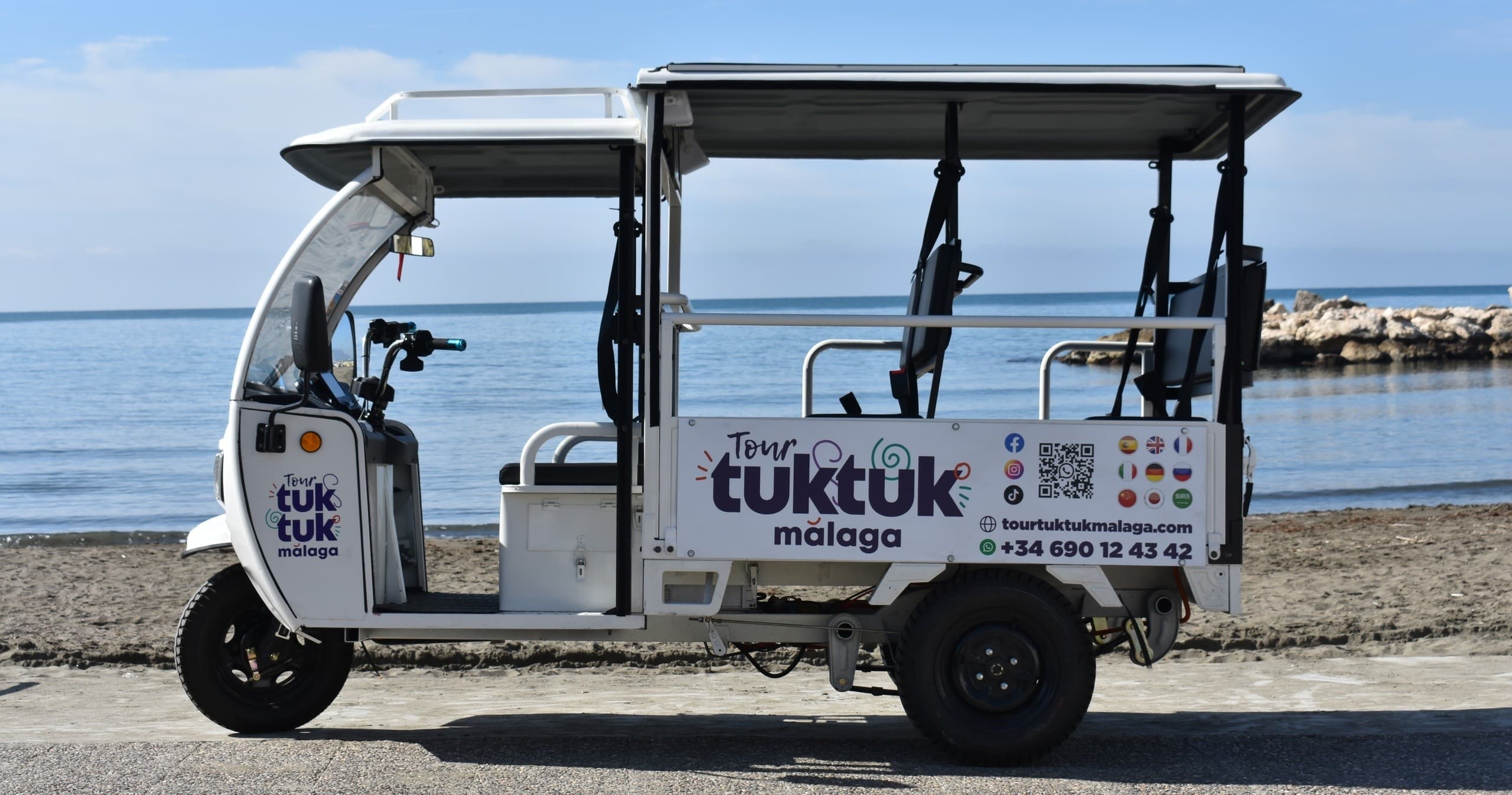 Open-air tuk-tuk tour along Málaga beachfront road