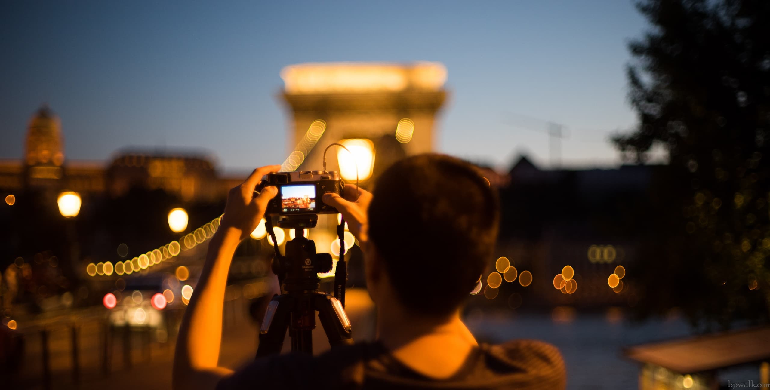 Photographer capturing Budapest Chain Bridge at night