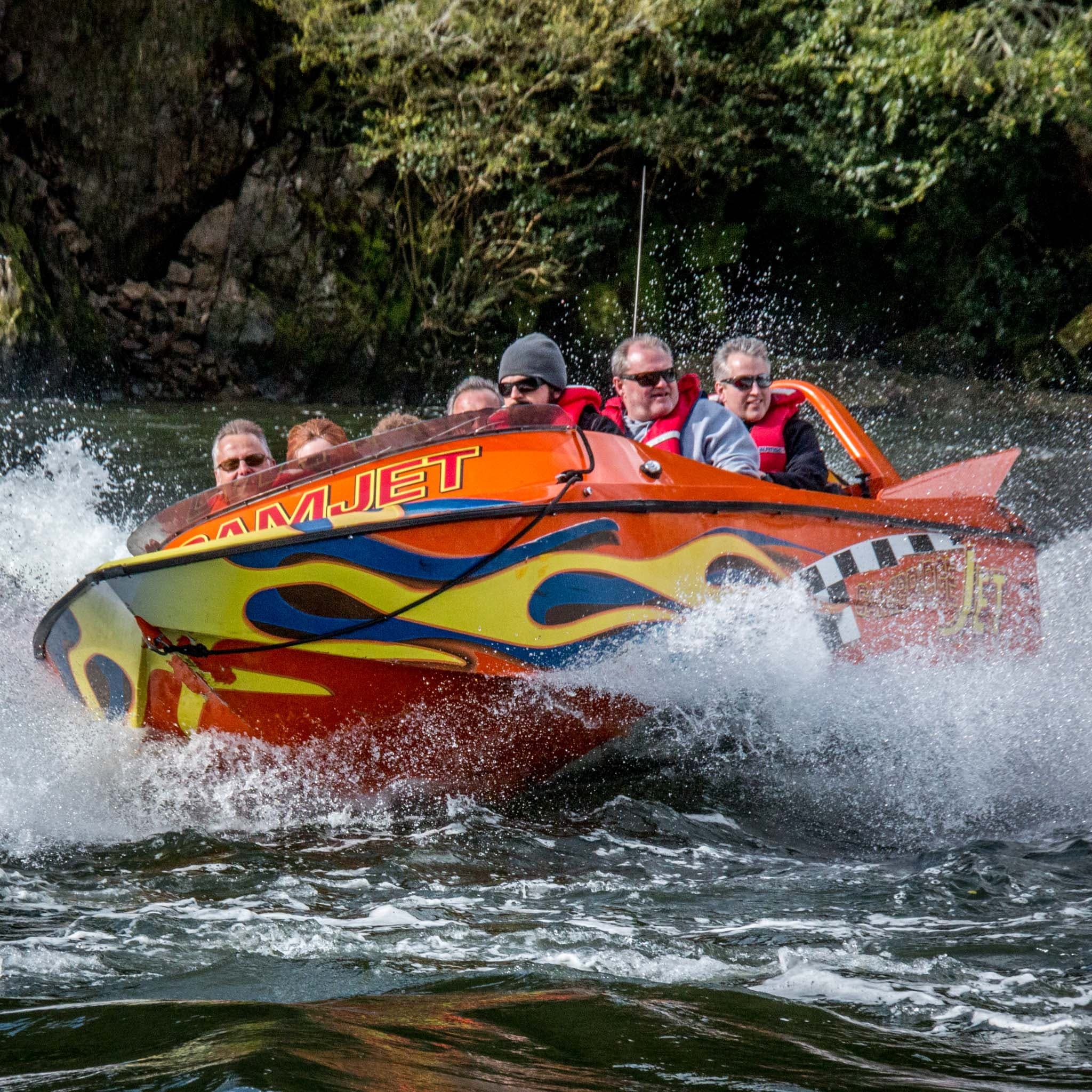 High-speed jetboat slicing river rapids, thrilling water ride