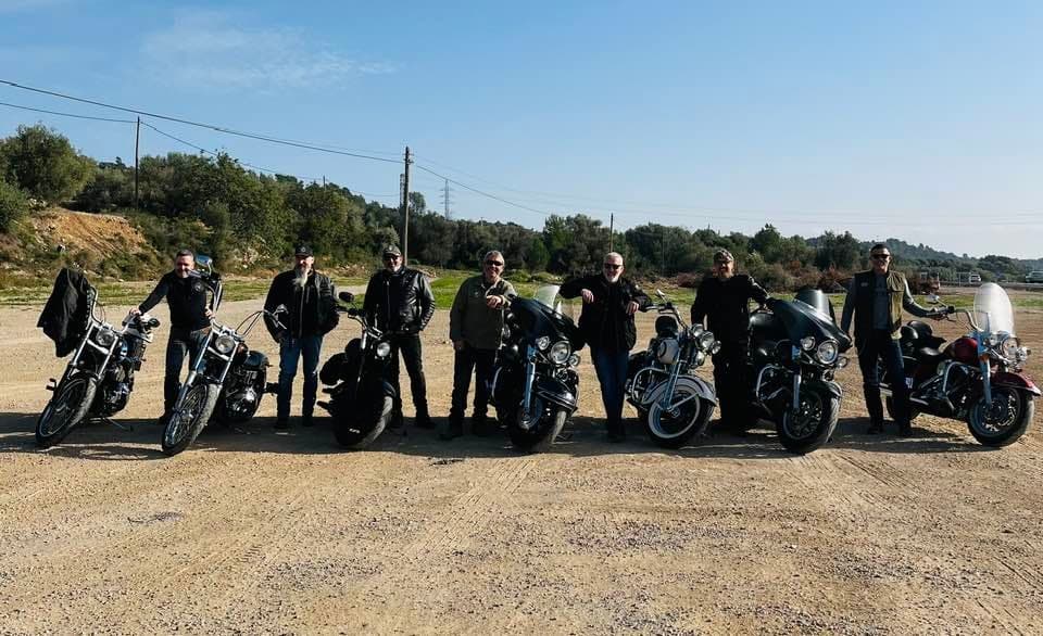Motorcycle tour group lined up on sunny rural road
