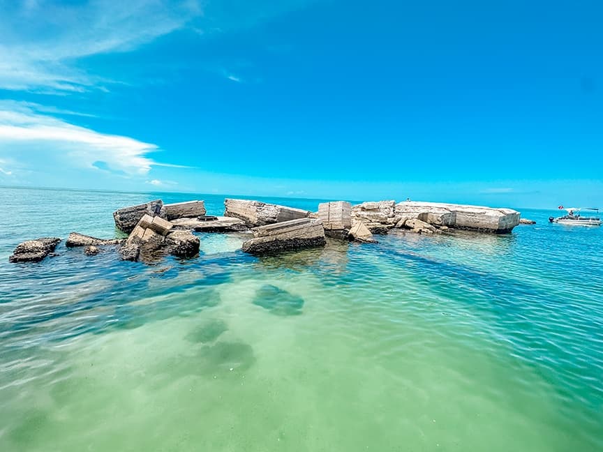 Turquoise shallow coastal flats with sandbar and clear sky