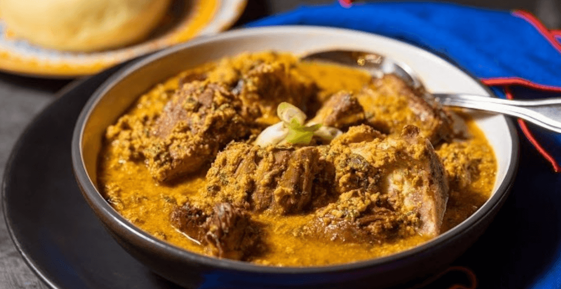 Spicy goat curry with flatbread on rustic wooden table, comfort meal