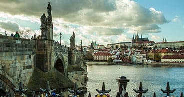 Scenic Charles Bridge over Vltava River with Prague skyline