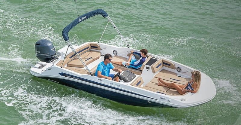 Aerial view of motorboat cruising green coastal waters