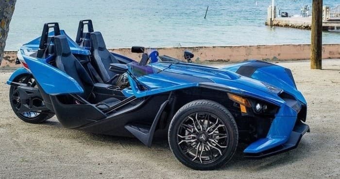 Blue slingshot near beachside pier for coastal scenic rides