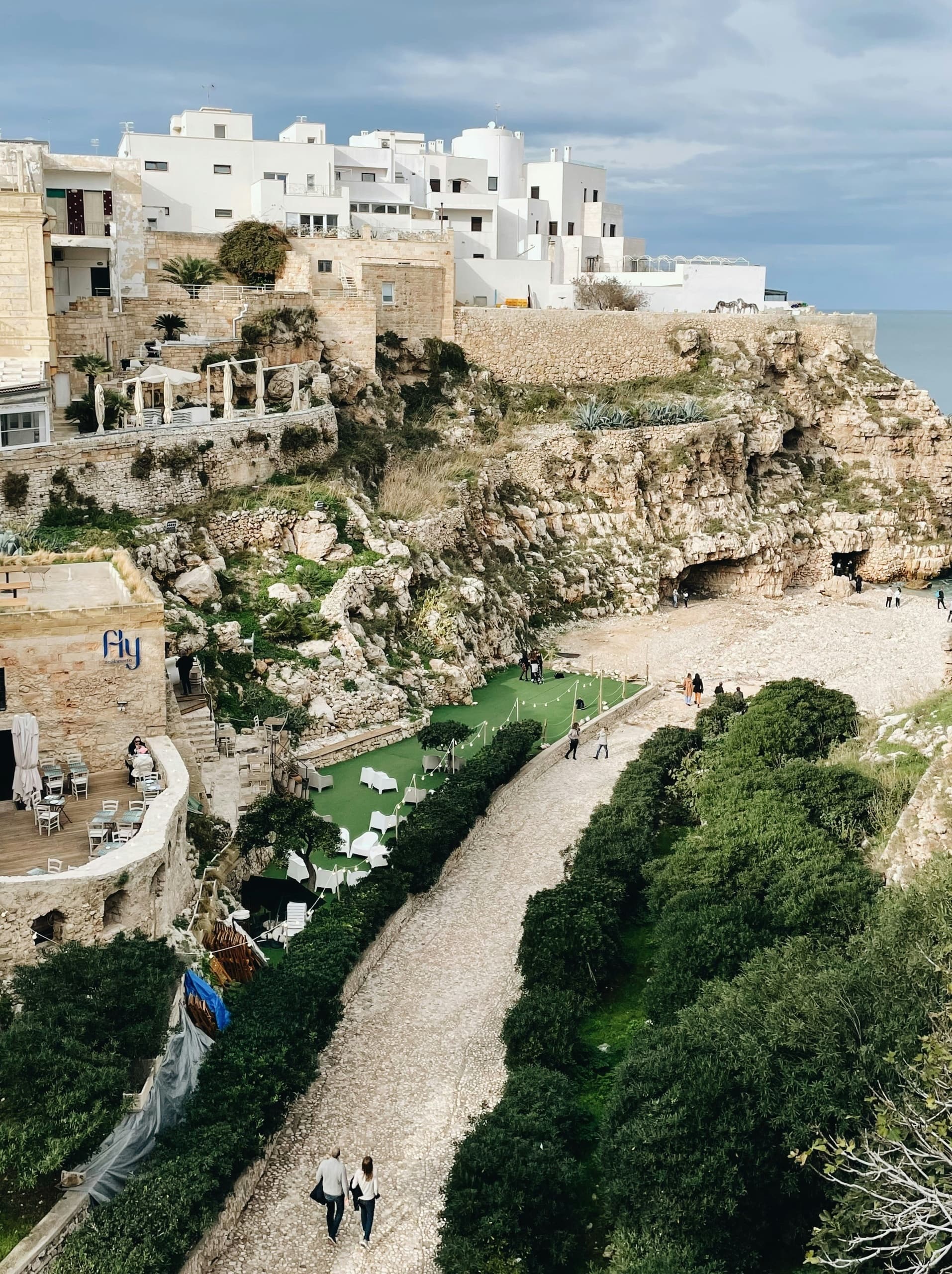 Wide coastal town view with rocky shore and blue ocean