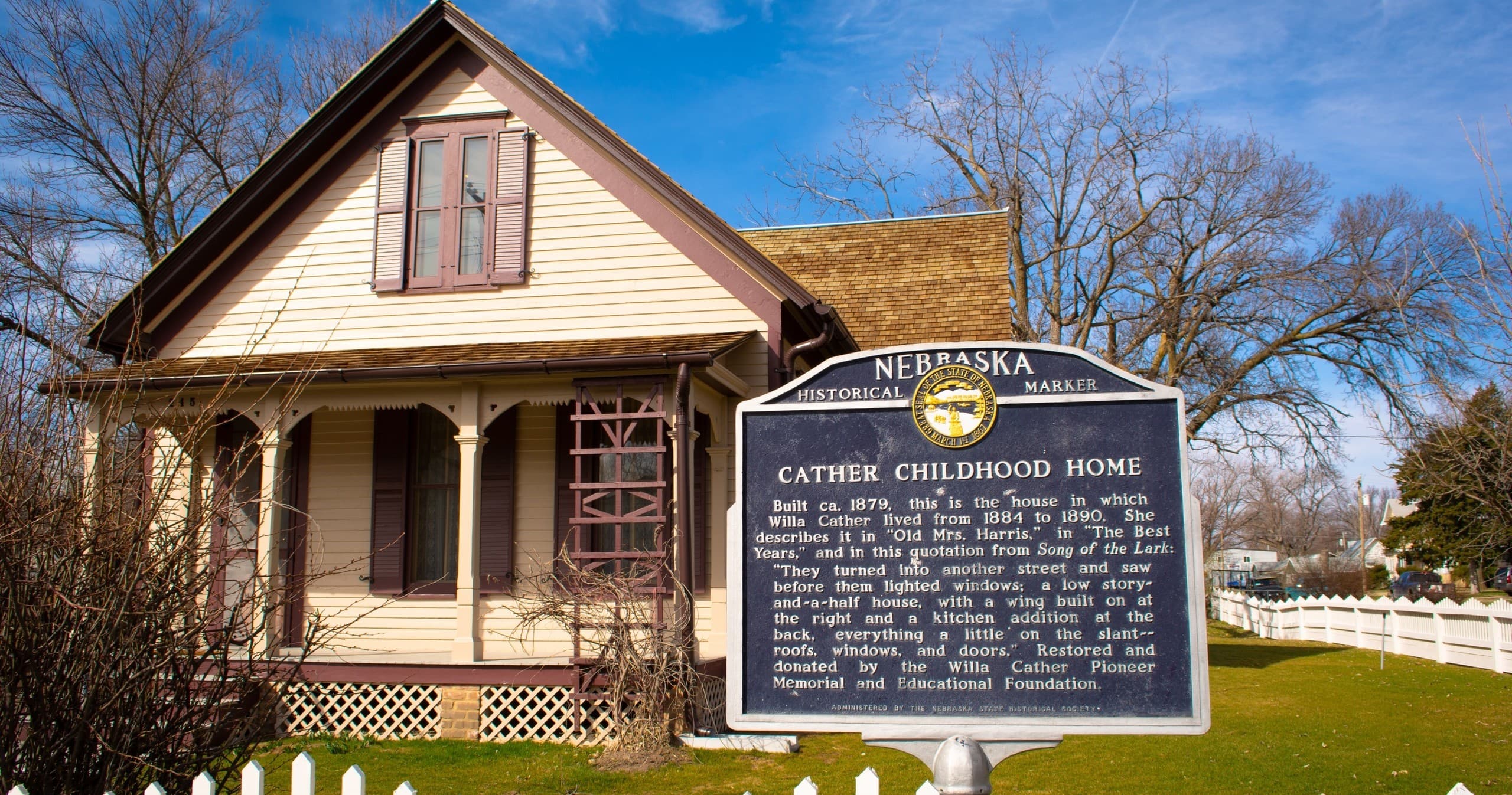 Victorian house museum facade with interpretive sign in Nebraska town