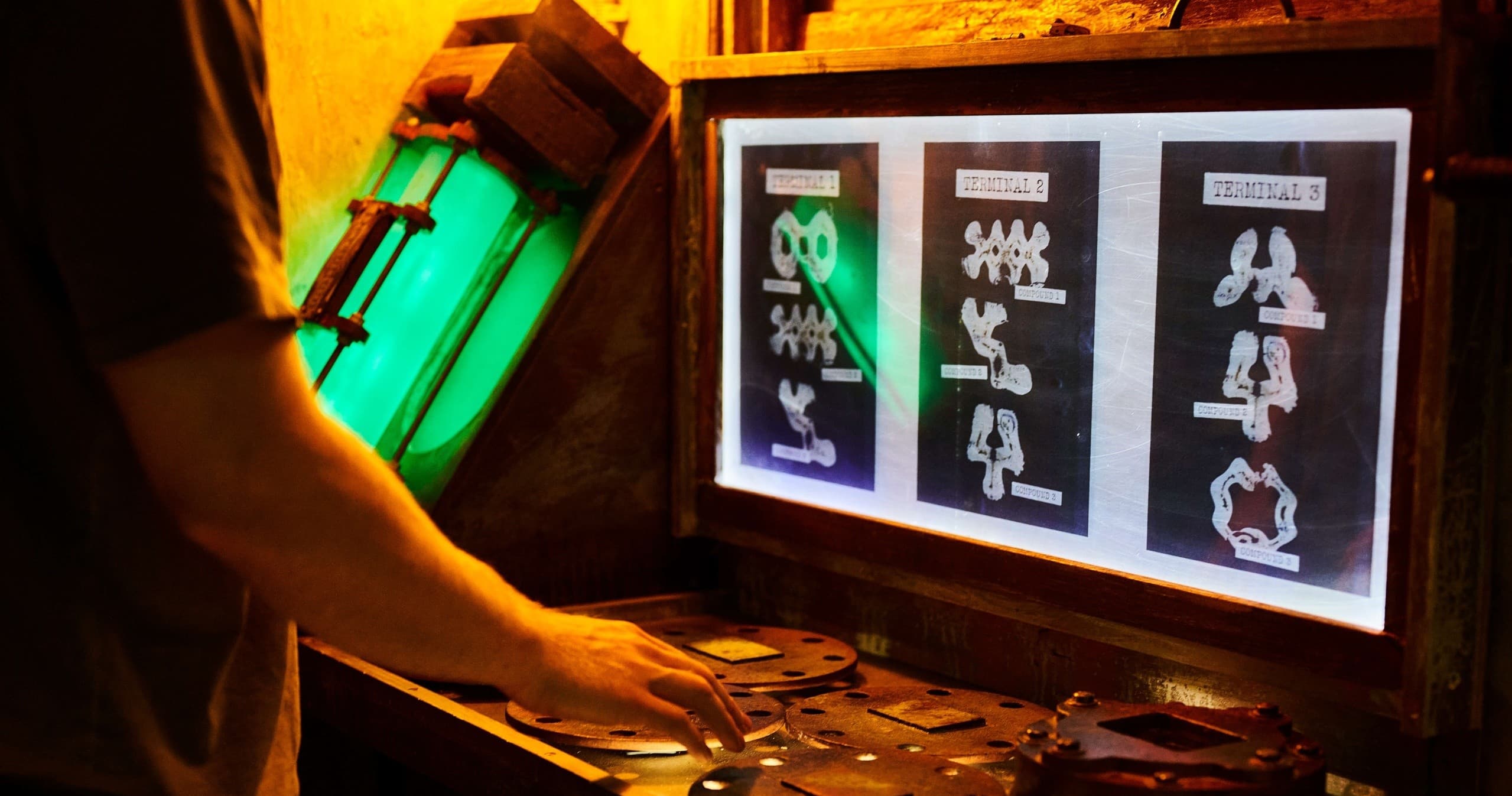 Person interacting with control panel and clues inside Canberra escape room